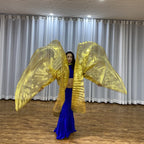 Dancer in blue costume performing with large gold metallic wings indoors