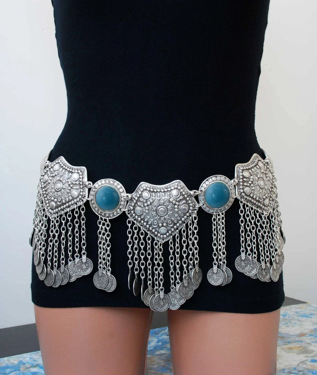 Boho silver coin belt with blue accents and intricate metalwork, worn on a mannequin