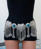 Boho silver coin belt with blue accents and intricate metalwork, worn on a mannequin