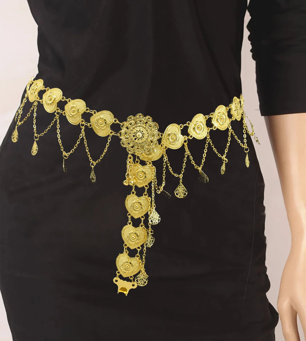 Gold filigree waist belt with dangling chains and floral design on black dress