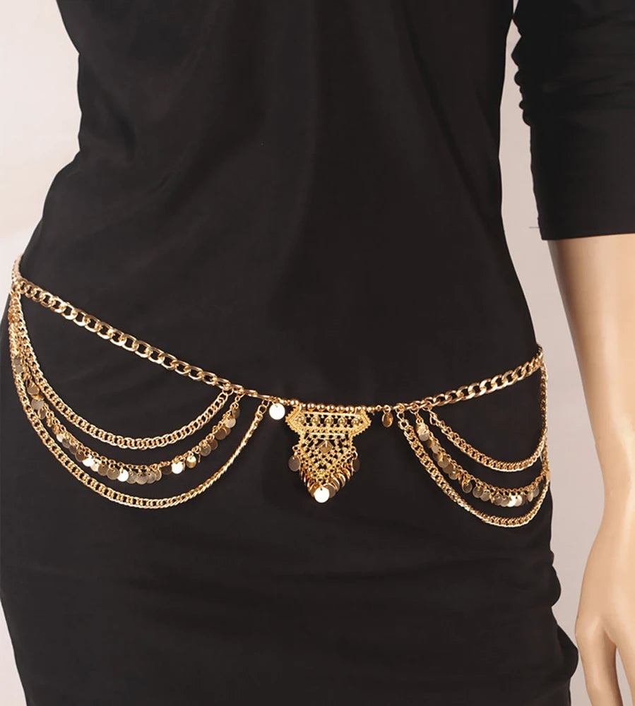 Gold layered chain waist belt with coins worn over a black dress, fashion accessory