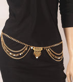 Gold layered chain waist belt with coins worn over a black dress, fashion accessory