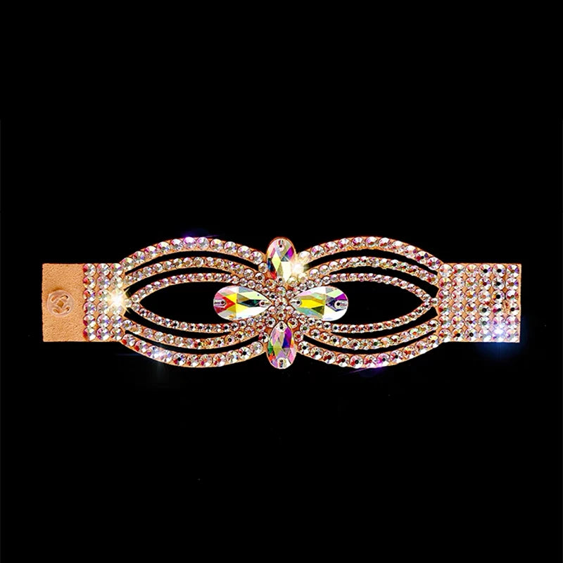 Gold hair clip with sparkling rhinestones and colorful crystals on black background
