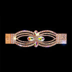 Gold hair clip with sparkling rhinestones and colorful crystals on black background