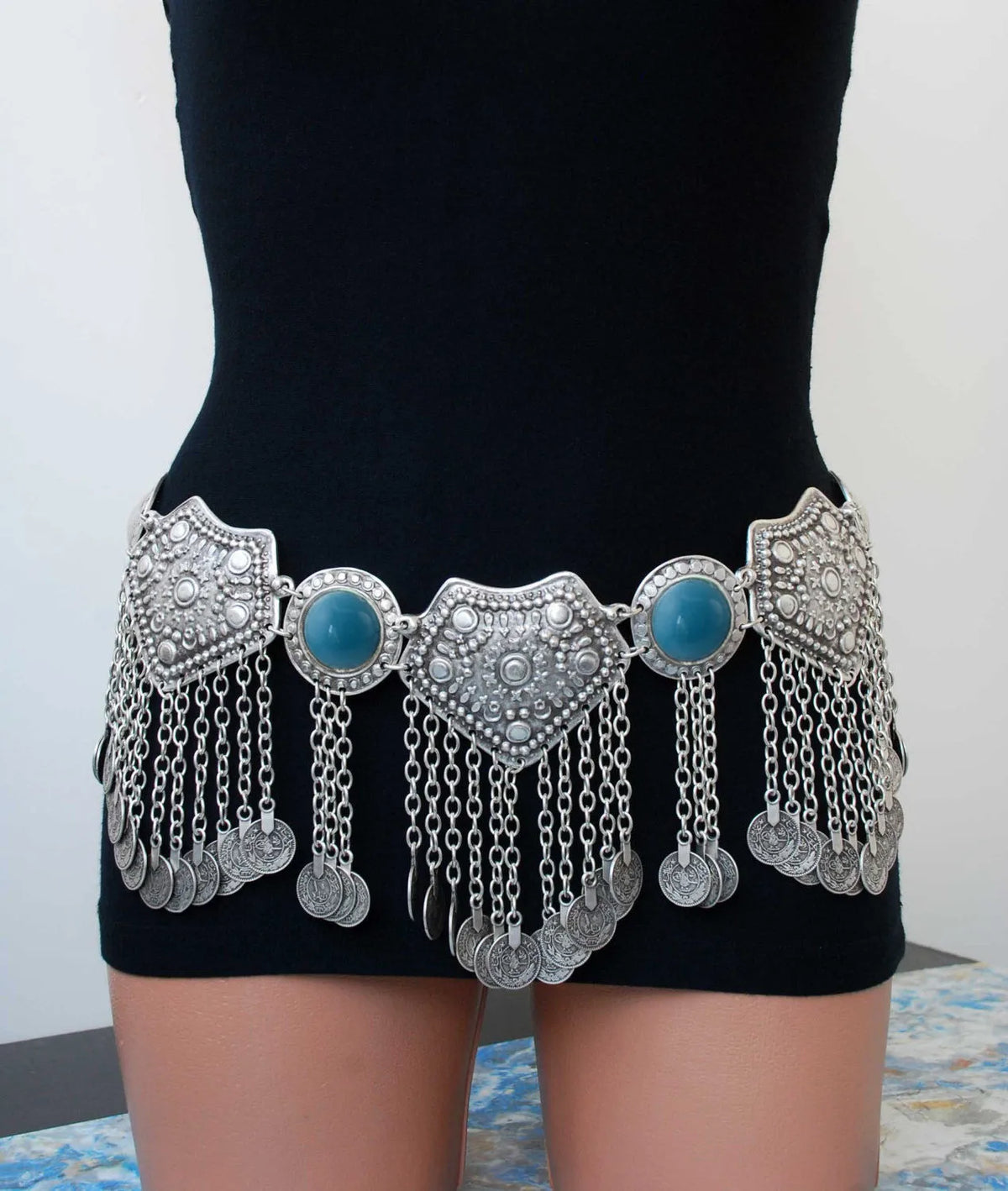 Bohemian style silver coin belt with blue stones and decorative chains worn on waist