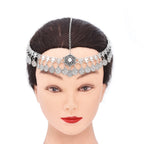 Silver coin headpiece with central floral pendant on mannequin head, boho hair accessory