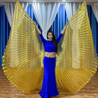 Woman in blue belly dance costume with large gold pleated wings indoors
