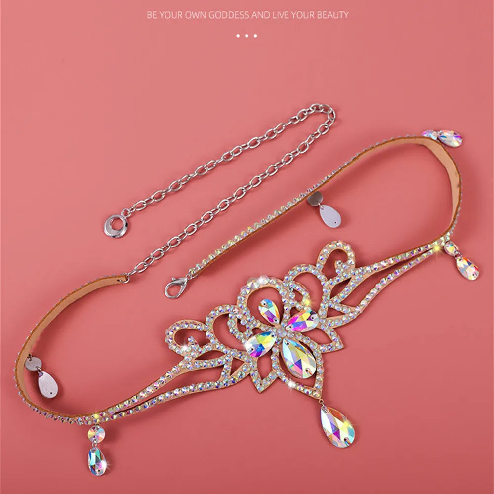 Sparkling crystal necklace with floral design and teardrop gems on a pink background