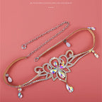 Sparkling crystal necklace with floral design and teardrop gems on a pink background