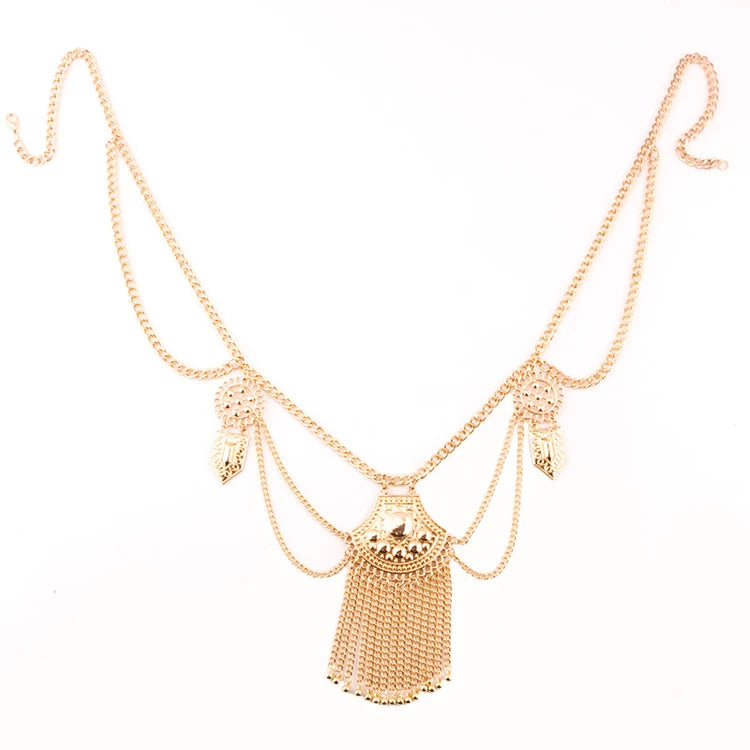 Gold layered statement necklace with decorative pendants and chain fringe on white background
