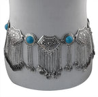 Silver boho coin belt with turquoise stones and dangling chain accents on mannequin.