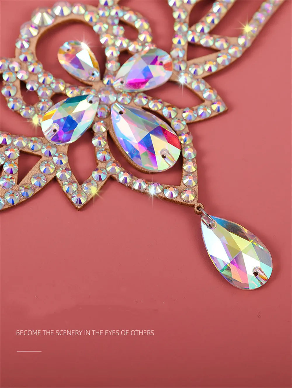 Sparkling crystal rhinestone necklace with teardrop gems on a pink background