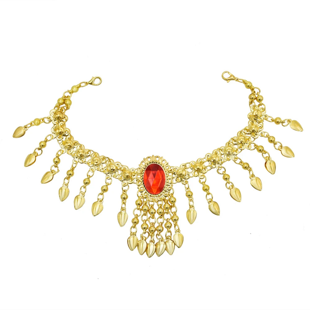 Gold statement necklace with red gemstone centerpiece and dangling gold leaf charms