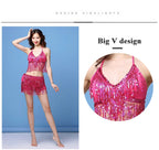 Woman in pink sequin fringe dance costume with V-neck halter top and matching skirt