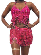 Woman wearing pink sequin fringe crop top and skirt set, festival fashion outfit