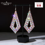 Iridescent crystal geometric drop earrings with diamond shape on black display stand