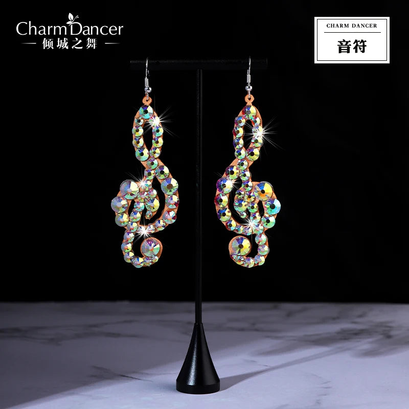 Crystal rhinestone treble clef dangle earrings on a black jewelry stand