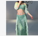 Woman wearing shimmering green sequin belly dance costume with off-shoulder sleeves