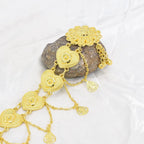 Gold heart chain hair accessory with floral details on white fabric background