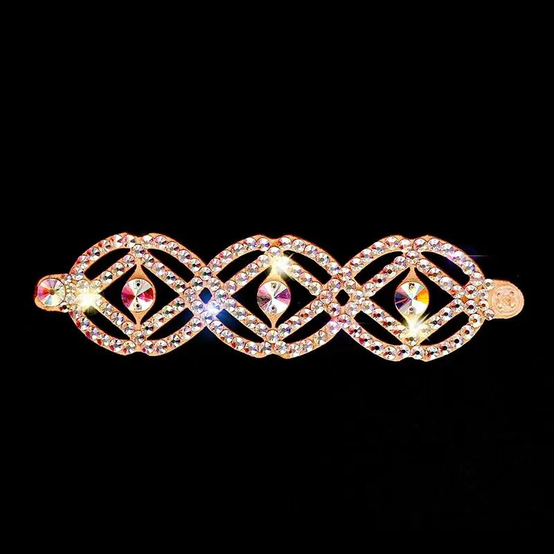 Rhinestone hair clip with gold-tone geometric lattice design on black background