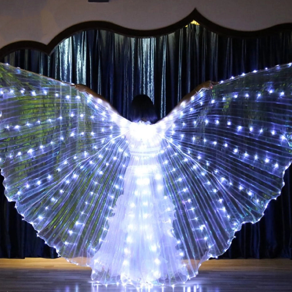 Person wearing large LED light up angel wings costume on stage, illuminated in the dark