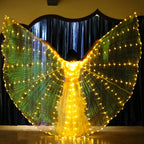 Person wearing illuminated LED light up wings costume on stage with glowing yellow lights