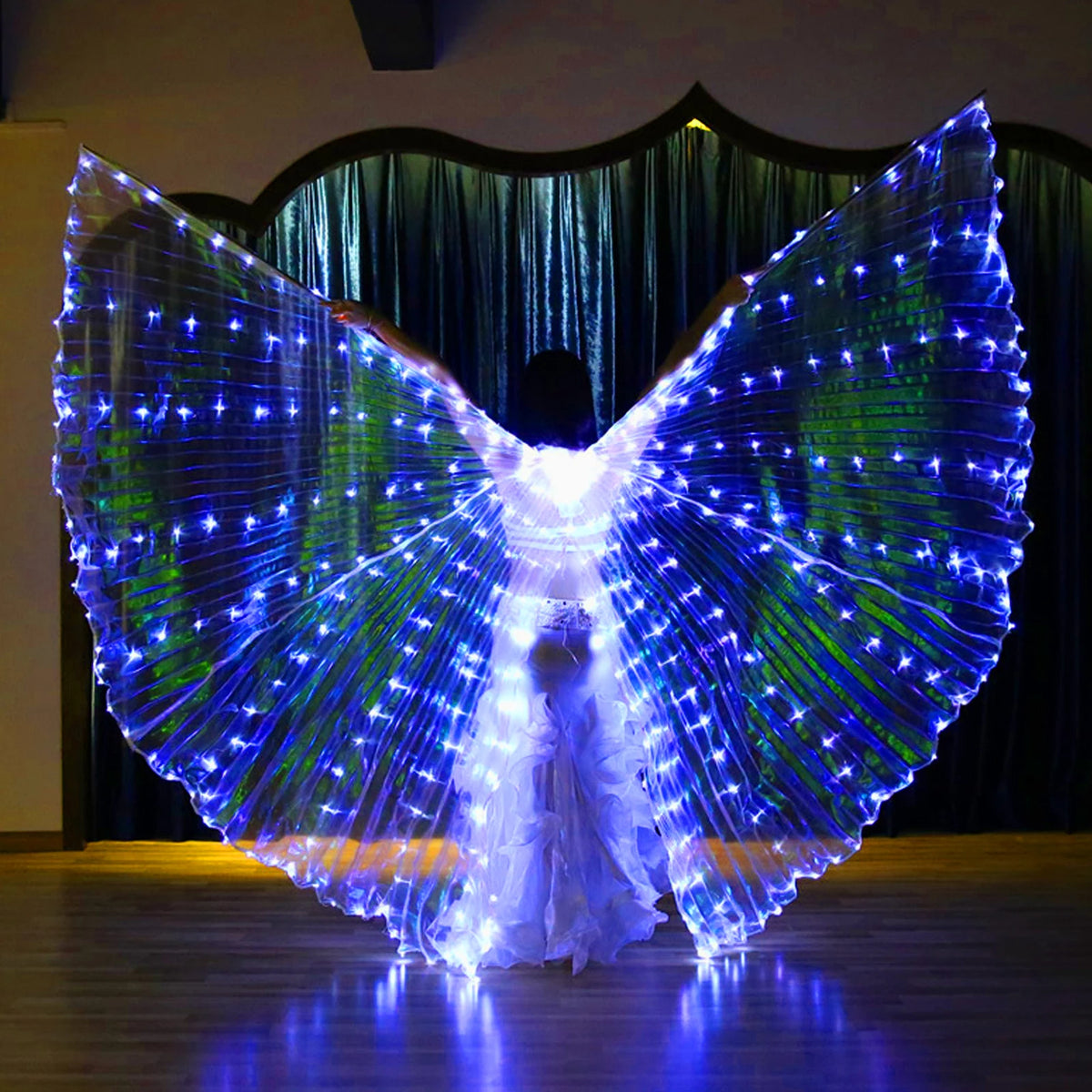 Person wearing illuminated LED wing costume in a dark room, ideal for dance or performance