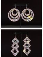 Two pairs of sparkly crystal statement earrings, one round and one geometric, on black background.
