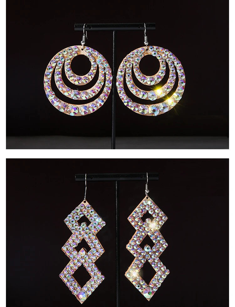 Two pairs of sparkly crystal statement earrings, one round and one geometric, on black background.