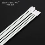 Set of white disposable swabs with plastic handles on a black background