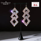 Geometric dangle earrings with sparkling rhinestones on a display stand, jewelry closeup