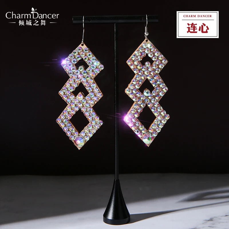 Geometric dangle earrings with sparkling rhinestones on a display stand, jewelry closeup