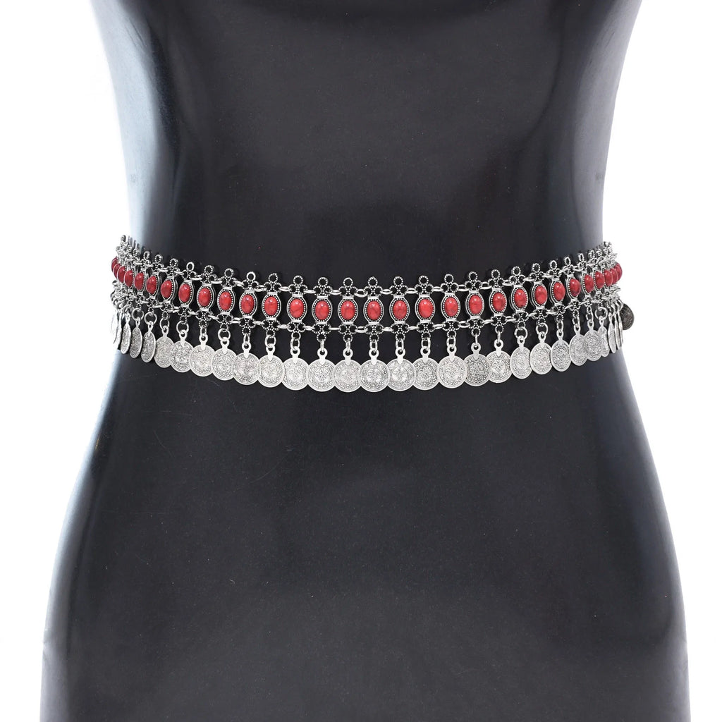 Boho silver waist chain belt with red stones and dangling coin charms on a black mannequin