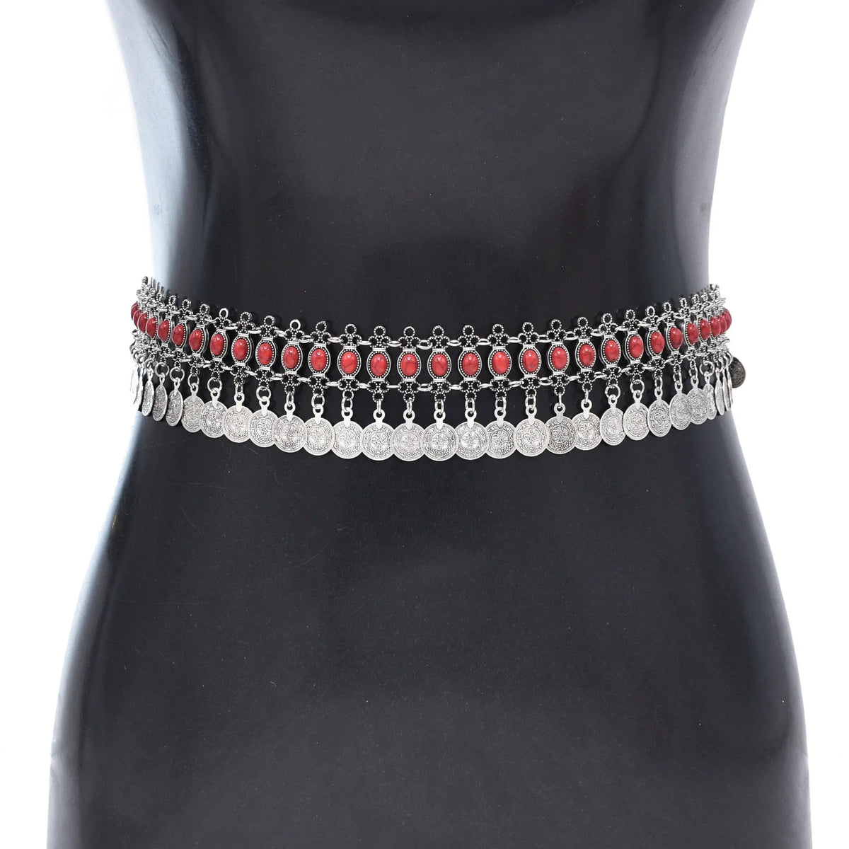 Boho silver waist chain belt with red stones and dangling coin charms on a black mannequin