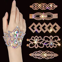 Hand wearing sparkling rhinestone bracelet with seven ornate crystal cuff designs on black.