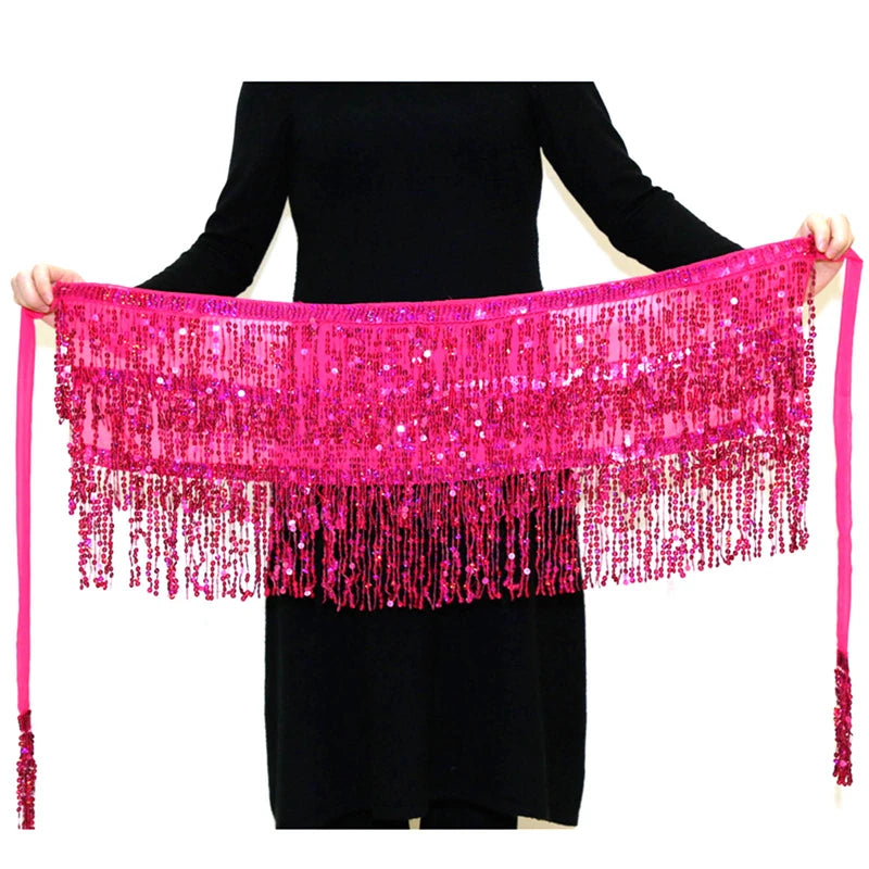 Person holding a pink sequined belly dance hip scarf with fringe and tassels