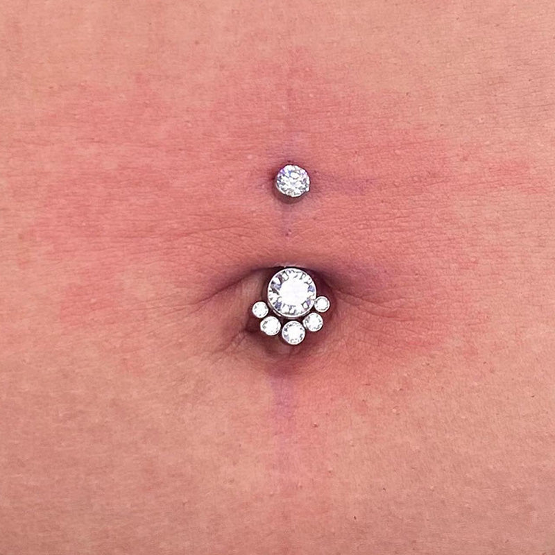 Close-up of a navel with double crystal belly button piercing jewelry
