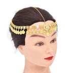 Gold coin headpiece with central jewel displayed on mannequin with dark hair