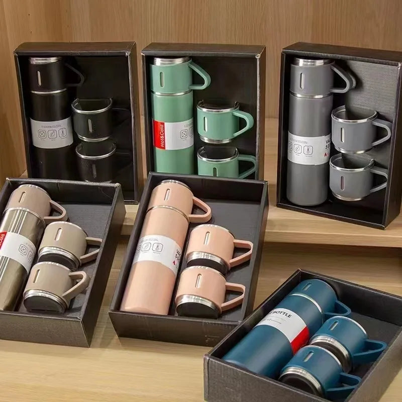 Assorted insulated travel mug and cup gift sets in various colors on wooden shelves
