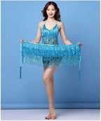 Woman modeling blue sequin fringe dance dress against a solid blue background