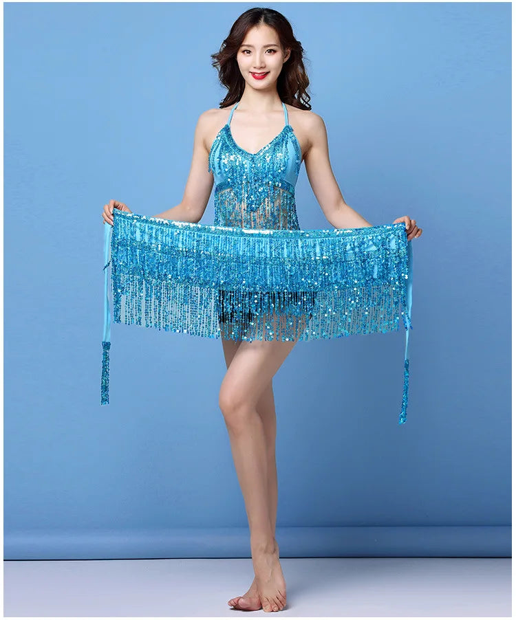 Woman modeling blue sequin fringe dance dress against a solid blue background