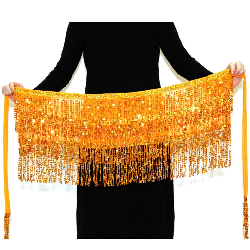 Person holding a yellow belly dance hip scarf with gold sequins and fringe beads.