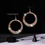Sparkling round hoop earrings with multi-colored rhinestones on display stands