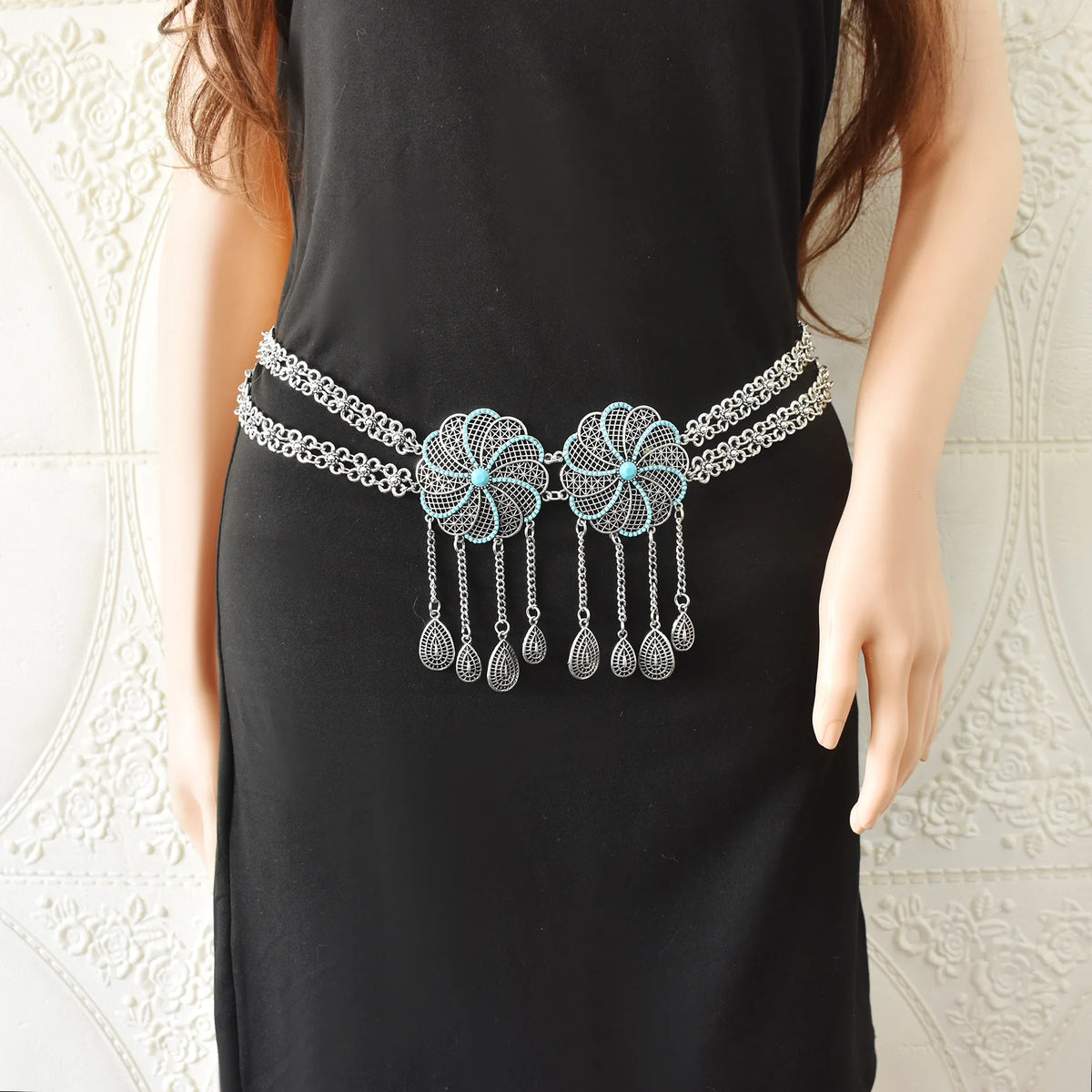 Boho silver chain belt with turquoise accents and dangling charms on black dress