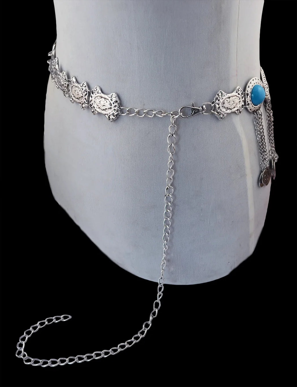Silver boho waist chain belt with decorative links and turquoise accent on mannequin