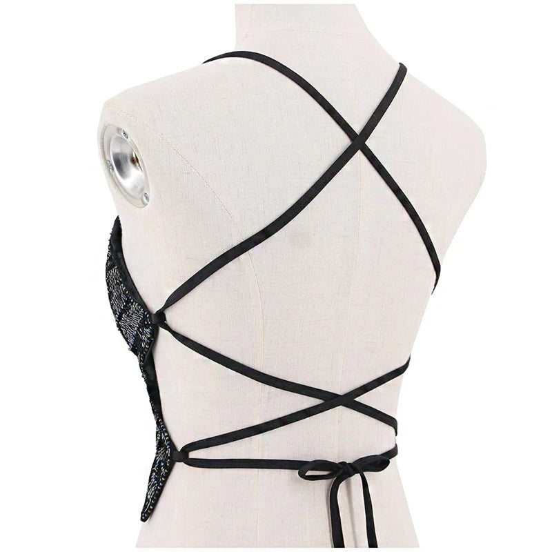 Back view of sequin halter crop top with black crisscross straps on mannequin