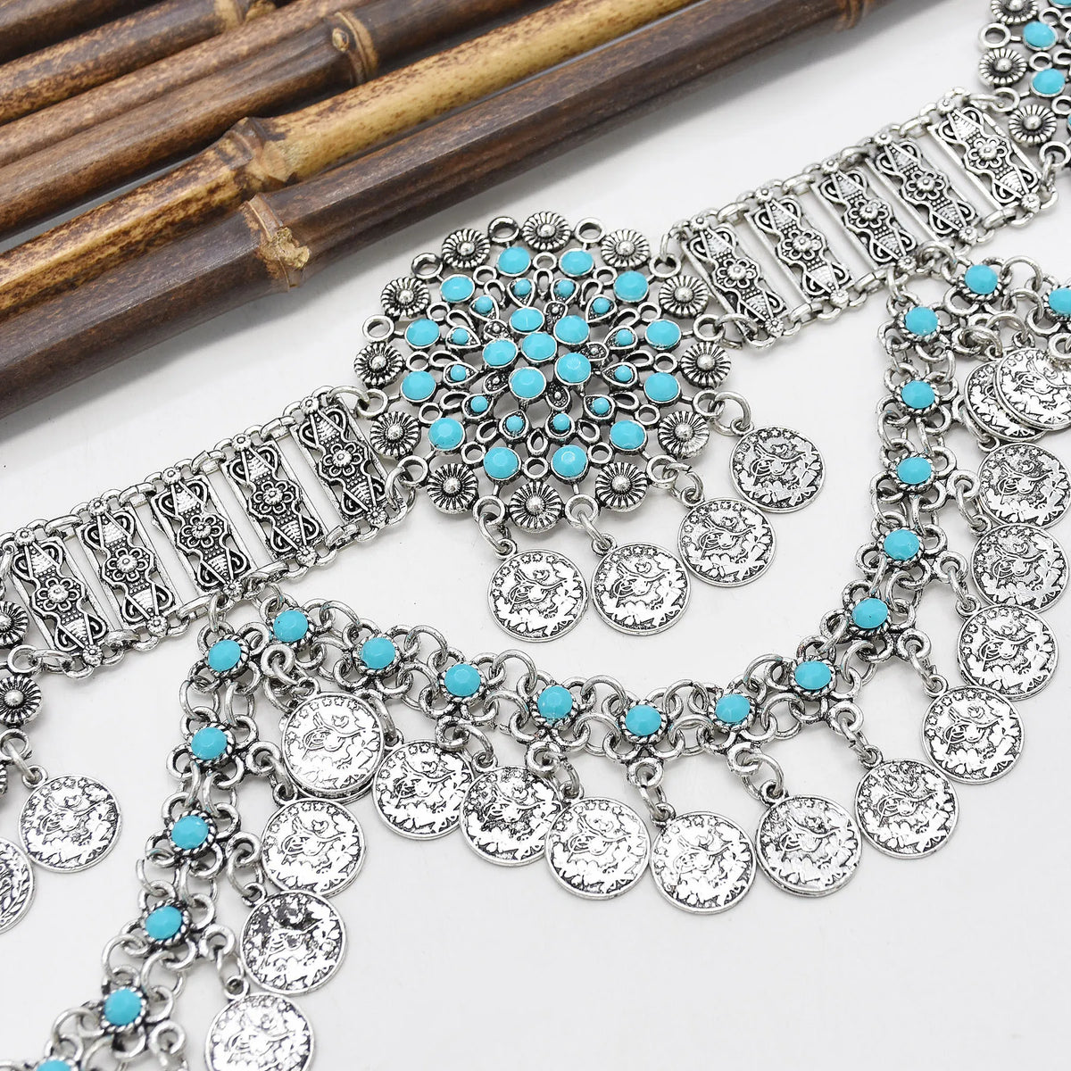 Boho silver coin necklace and bracelet set with turquoise beads on white background
