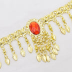 Gold decorative chain belt with dangling teardrop charms and red gemstone accent