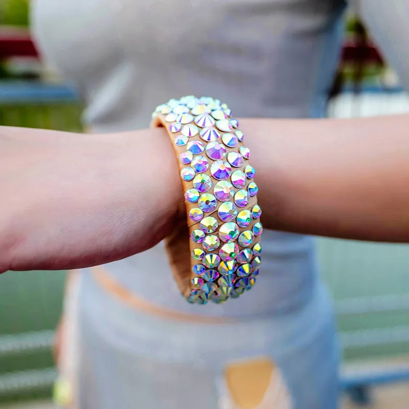 Hand wearing a sparkly rhinestone-studded bracelet outdoors