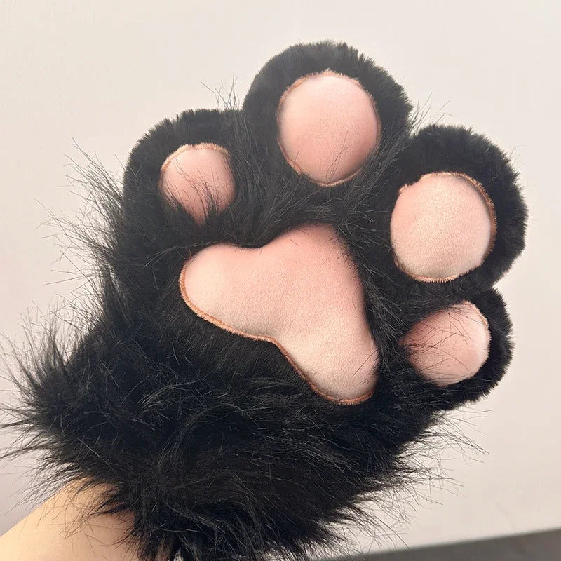 Plush black cat paw glove with soft pink pads, novelty costume accessory against white background